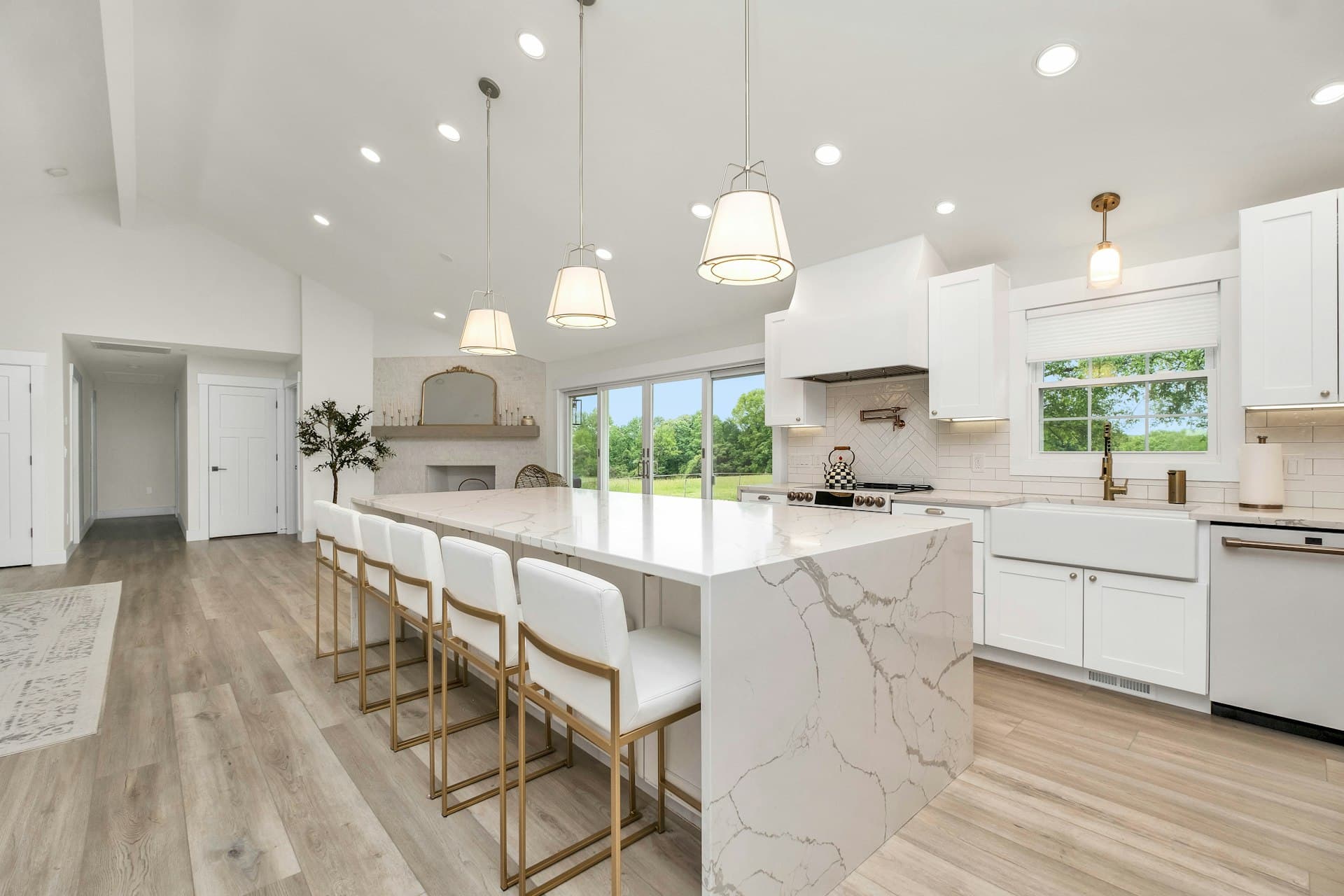 A bright, newly renovated kitchen with fresh cabinets, flooring and trim